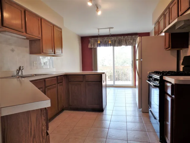 a kitchen with a sink window and cabinets