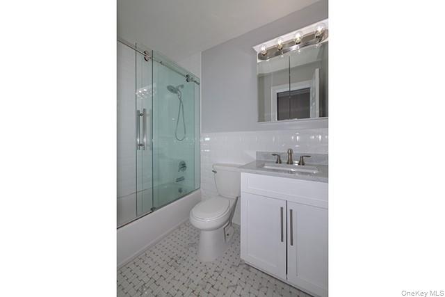 384 Cassa Loop, Unit 384 Holtsville, NY 11742 - Photo 14 of 14 a bathroom with a sink a toilet and shower