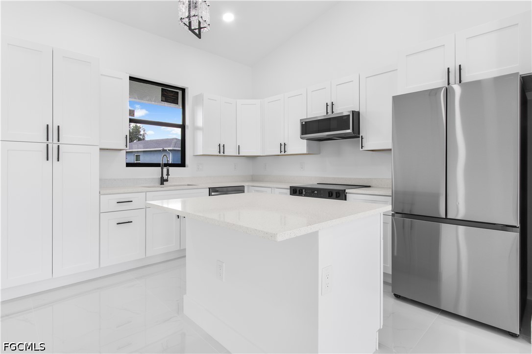 3004 South Tulip Road LaBelle, FL 33935 - Photo 11 of 24 a kitchen with white cabinets and stainless steel appliances