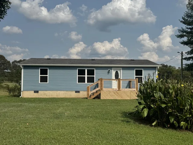 a front view of house with yard and green space