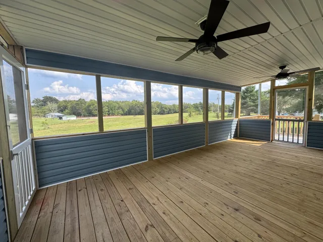 a view of outdoor space with wooden floor and windows
