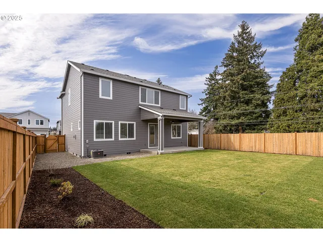 a backyard of a house with table and chairs
