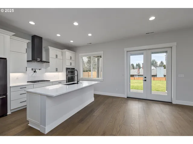 a kitchen with a stove a sink and a refrigerator