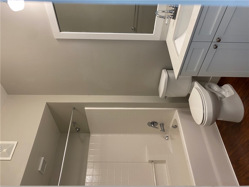 208 West 22nd Street, Unit B Bryan, TX 77803 - Photo 11 of 15 a bathroom with a sink a toilet and shower