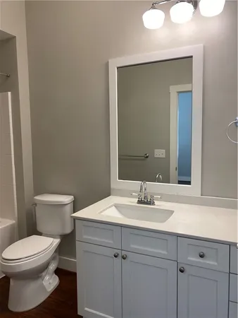 a bathroom with a sink a toilet and mirror