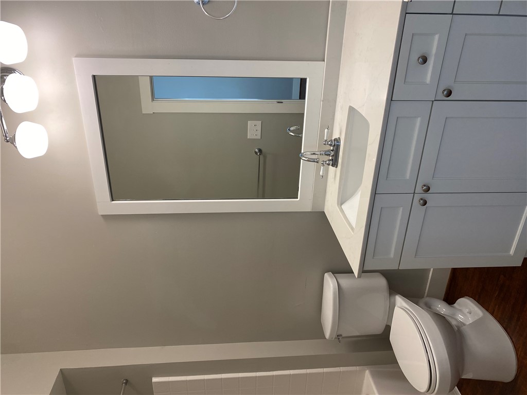 208 West 22nd Street, Unit B Bryan, TX 77803 - Photo 12 of 15 a bathroom with a sink a toilet and mirror