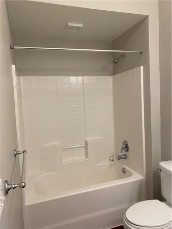a bathroom with a toilet and a bathtub