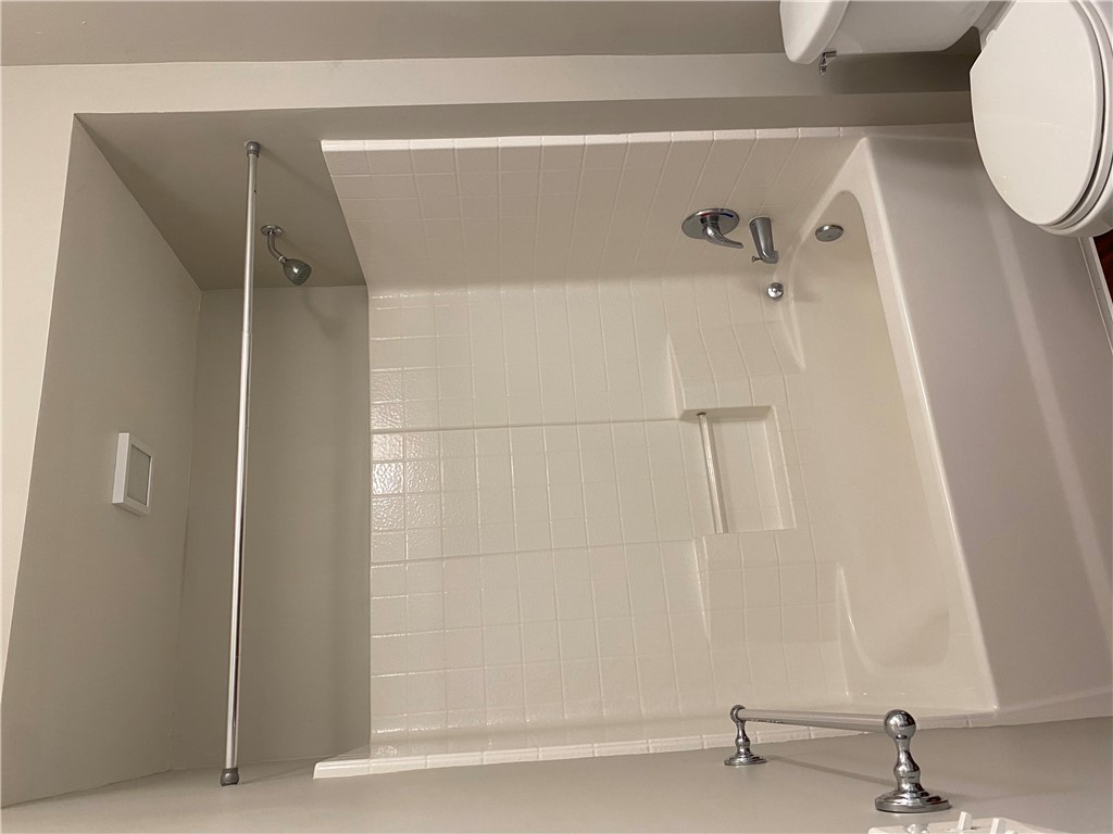 208 West 22nd Street, Unit B Bryan, TX 77803 - Photo 13 of 15 a bathroom with a toilet and a bathtub