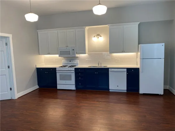 a kitchen with stainless steel appliances a refrigerator and a stove