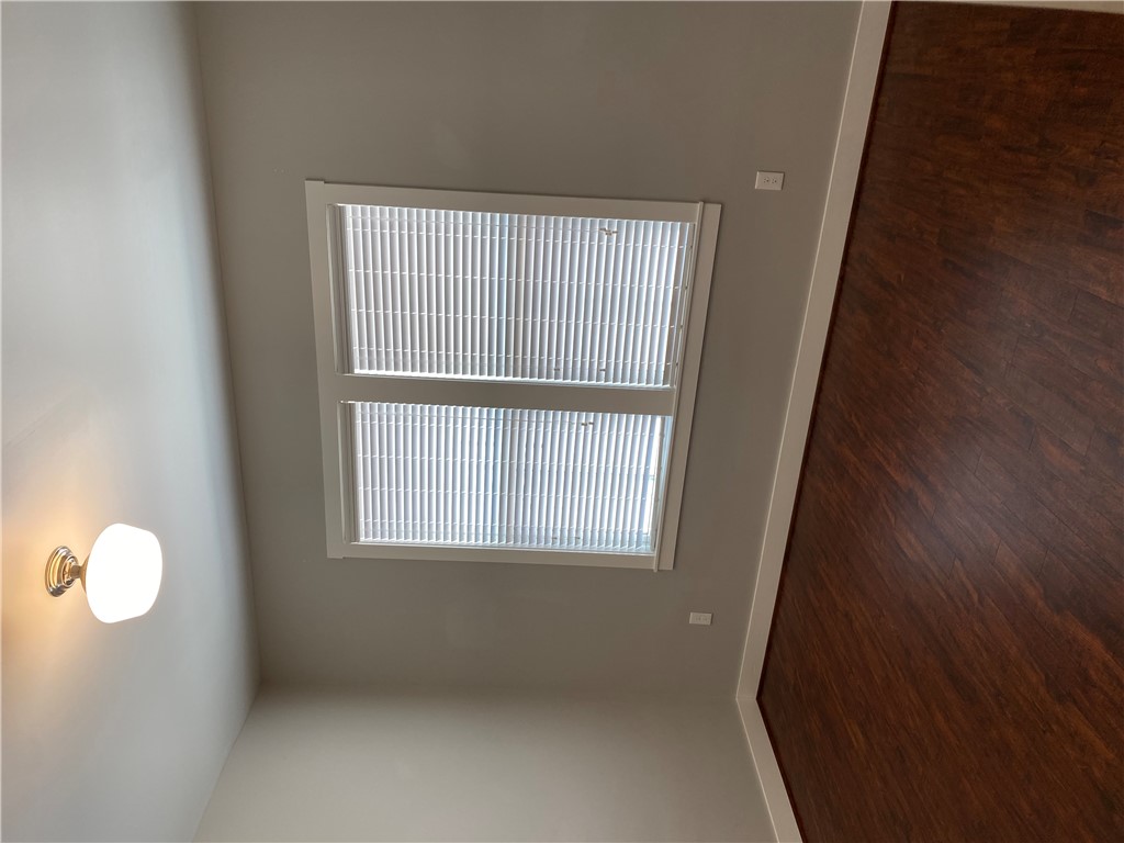 208 West 22nd Street, Unit B Bryan, TX 77803 - Photo 8 of 15 an empty room with wooden floor and windows