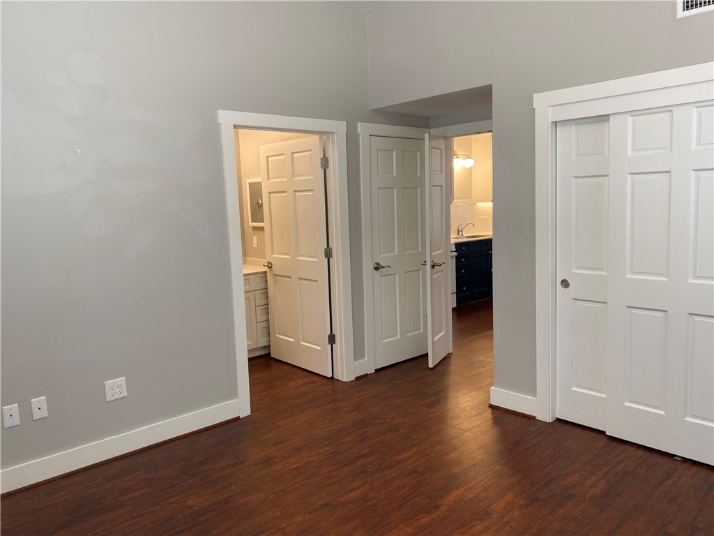 208 West 22nd Street, Unit B Bryan, TX 77803 - Photo 10 of 15 an empty room with wooden floor and windows
