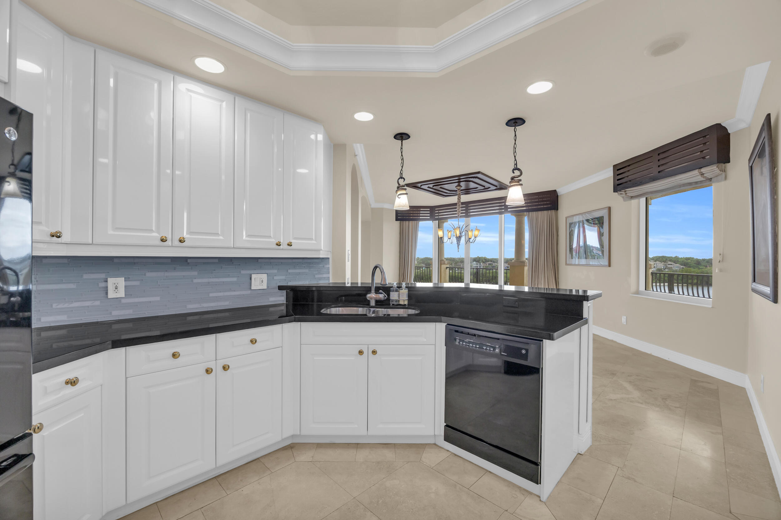 340 South US Highway 1, Unit 408 Jupiter, FL 33477 - Photo 11 of 53 a kitchen with granite countertop white cabinets and white appliances