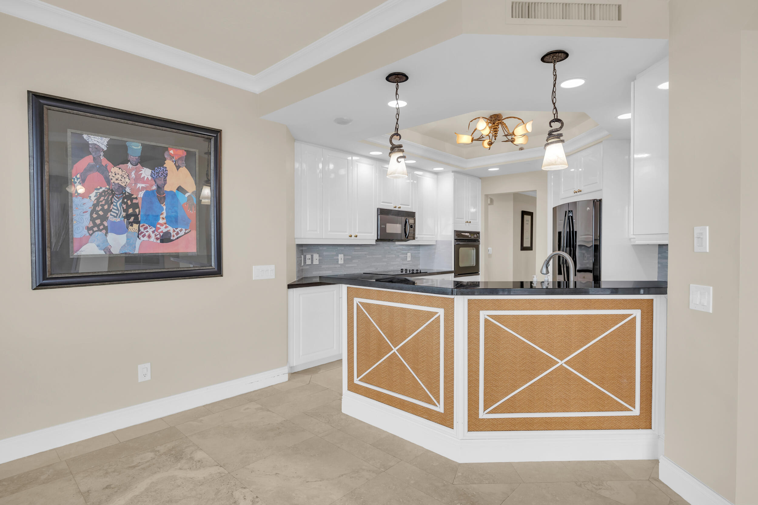 340 South US Highway 1, Unit 408 Jupiter, FL 33477 - Photo 13 of 53 a view of a kitchen with a sink and chandelier