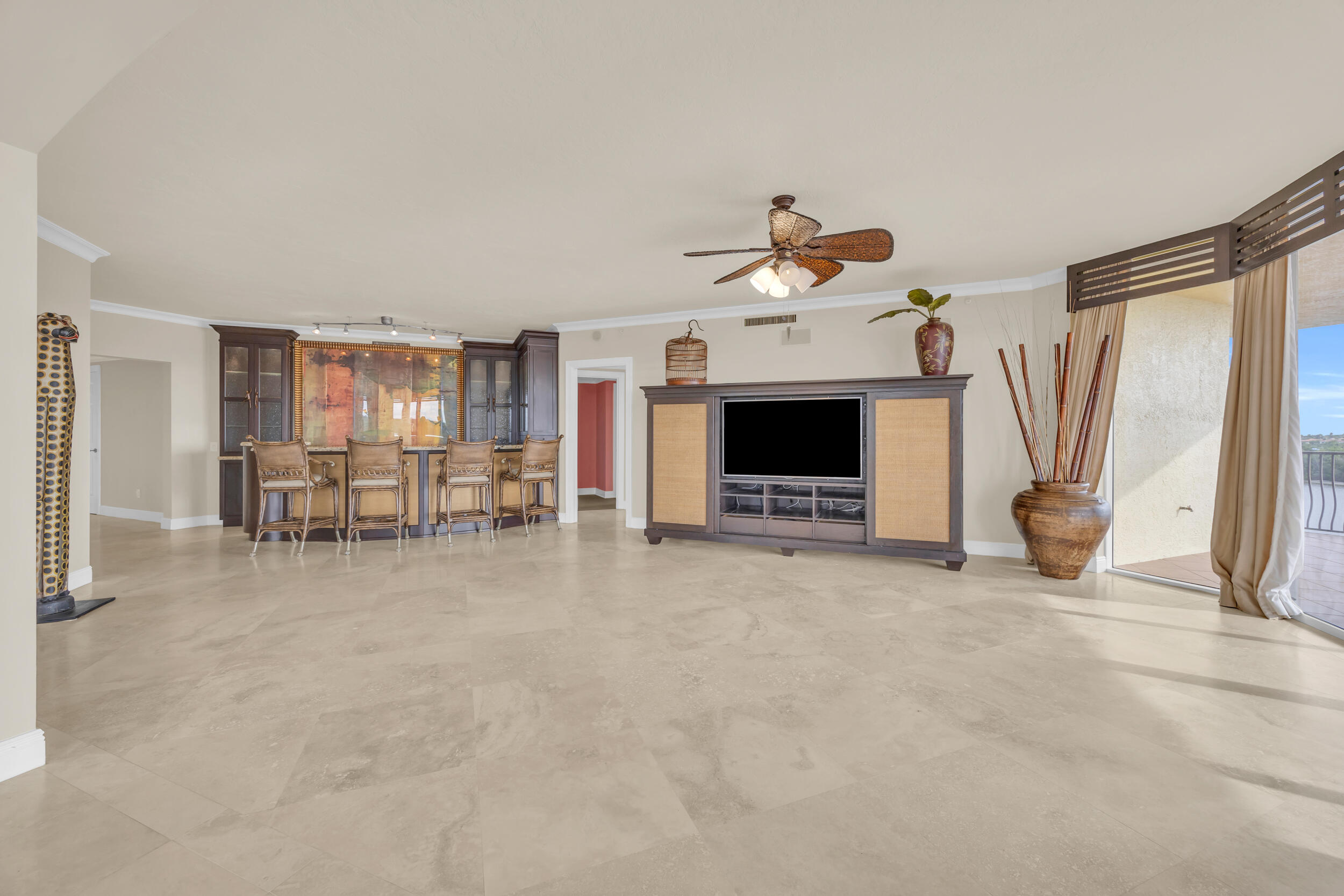 340 South US Highway 1, Unit 408 Jupiter, FL 33477 - Photo 25 of 53 a living room with furniture and a flat screen tv