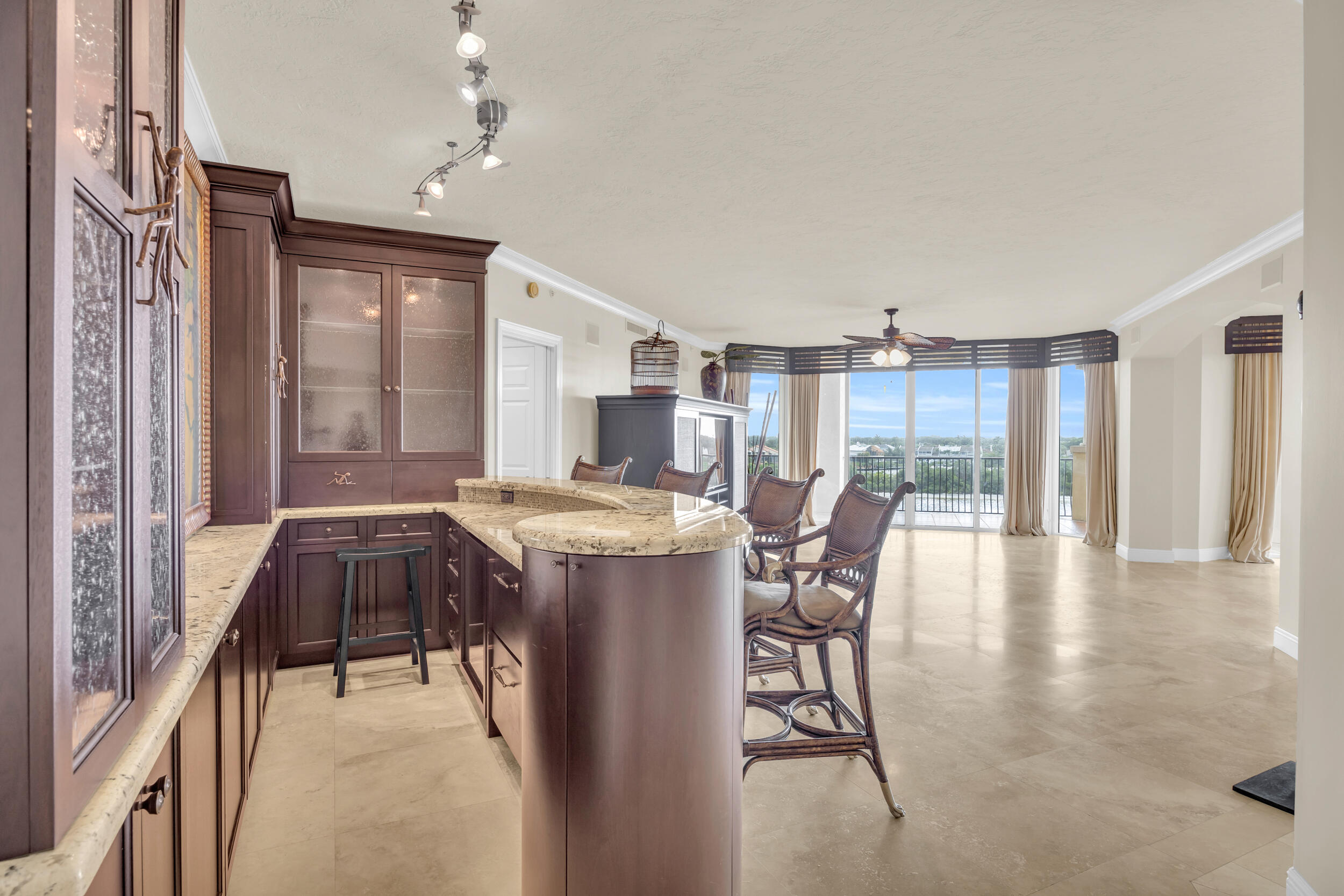 340 South US Highway 1, Unit 408 Jupiter, FL 33477 - Photo 27 of 53 a dining hall with stainless steel appliances kitchen island granite countertop a table chairs and a refrigerator