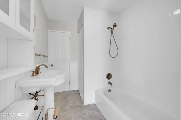 a bathroom with a sink a toilet and a bathtub