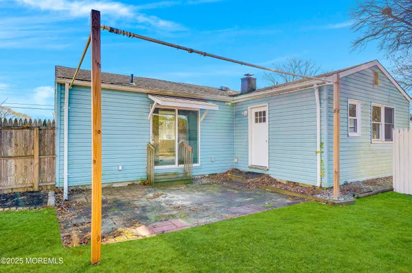 a view of a backyard with wooden fence