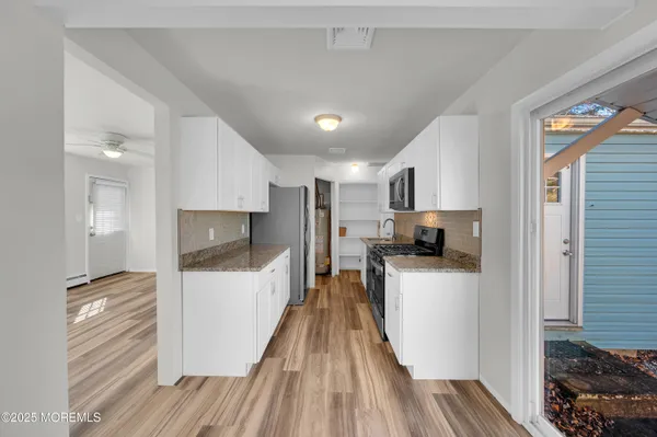 a kitchen with refrigerator and cars