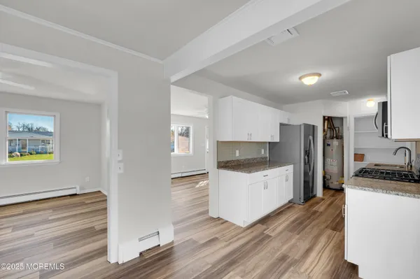 a kitchen with a refrigerator and a stove top oven