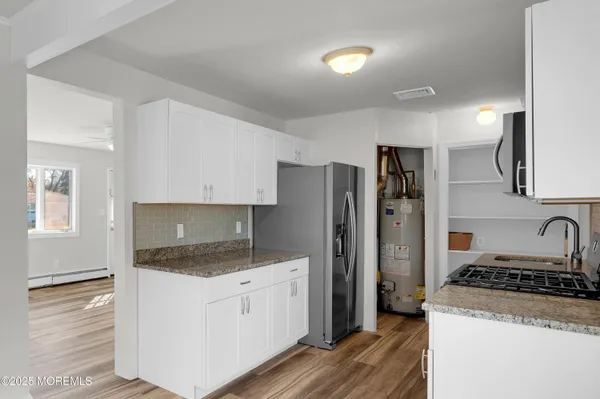 a kitchen with a refrigerator stove and sink