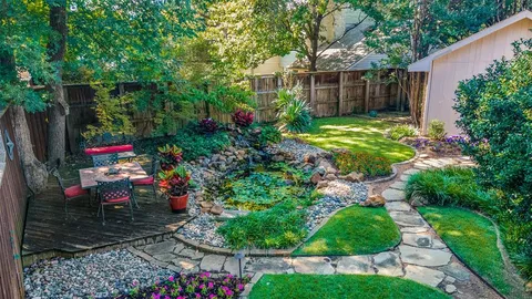 an aerial view of a house with swimming pool and garden