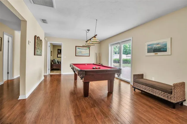 a living room with furniture a window and wooden floor