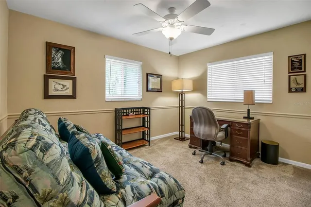a view of a workspace with furniture and a window