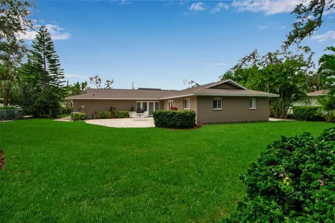 a front view of a house with a garden and yard