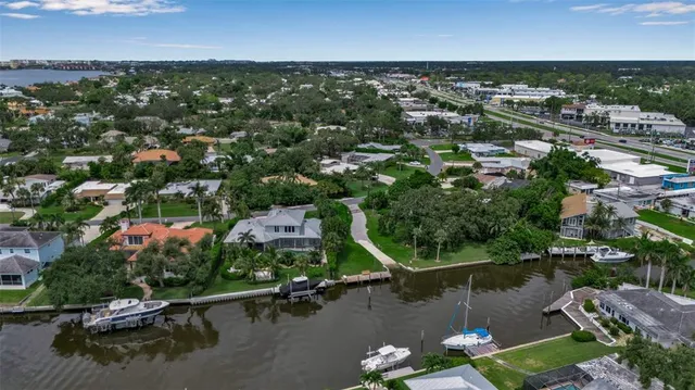 an aerial view of residential houses with outdoor space and lake view