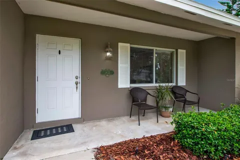 a balcony with furniture and a potted plant