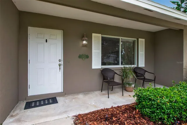 a balcony with furniture and a potted plant