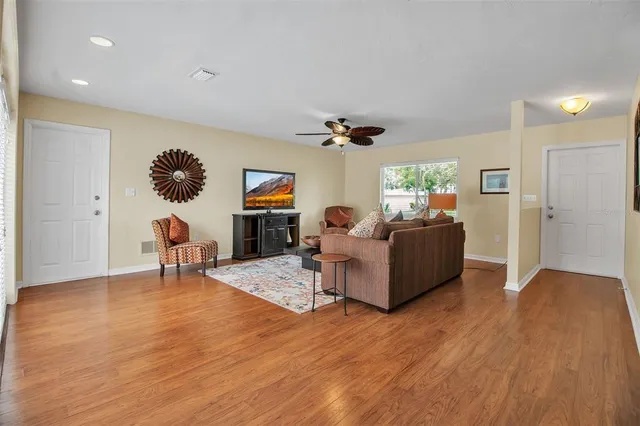 a living room with furniture and a wooden floor