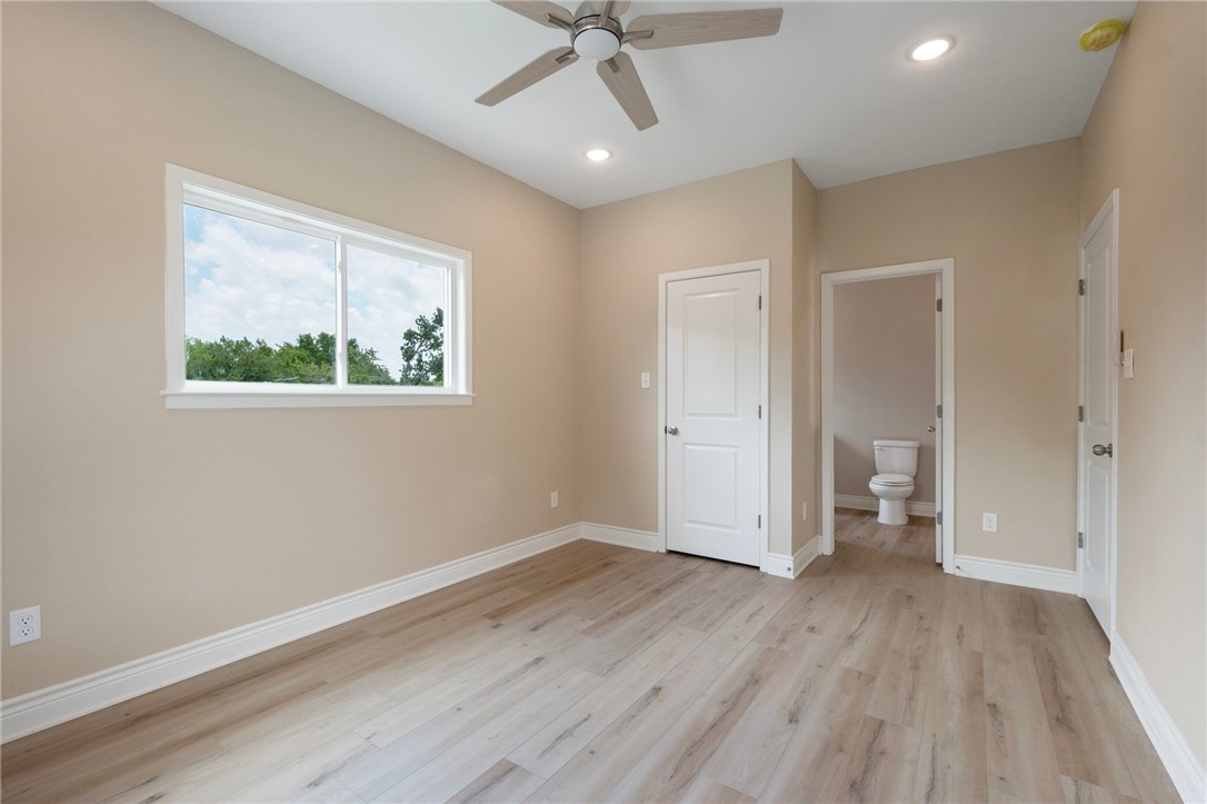 3213 Link Street, Unit 116 Bryan, TX 77801 - Photo 13 of 27 wooden floor in an empty room with a window
