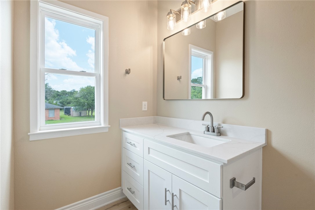 3213 Link Street, Unit 116 Bryan, TX 77801 - Photo 14 of 27 a bathroom with a sink vanity and a mirror