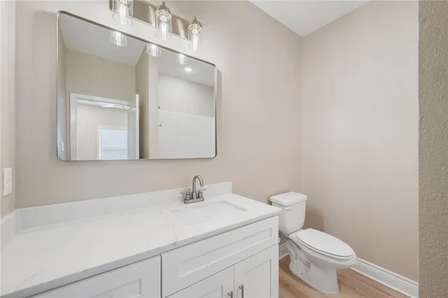 an empty room with wooden floor and window