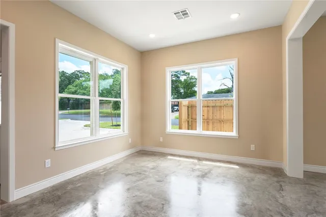 a kitchen with stainless steel appliances a sink a stove a microwave a sink a refrigerator with white cabinets