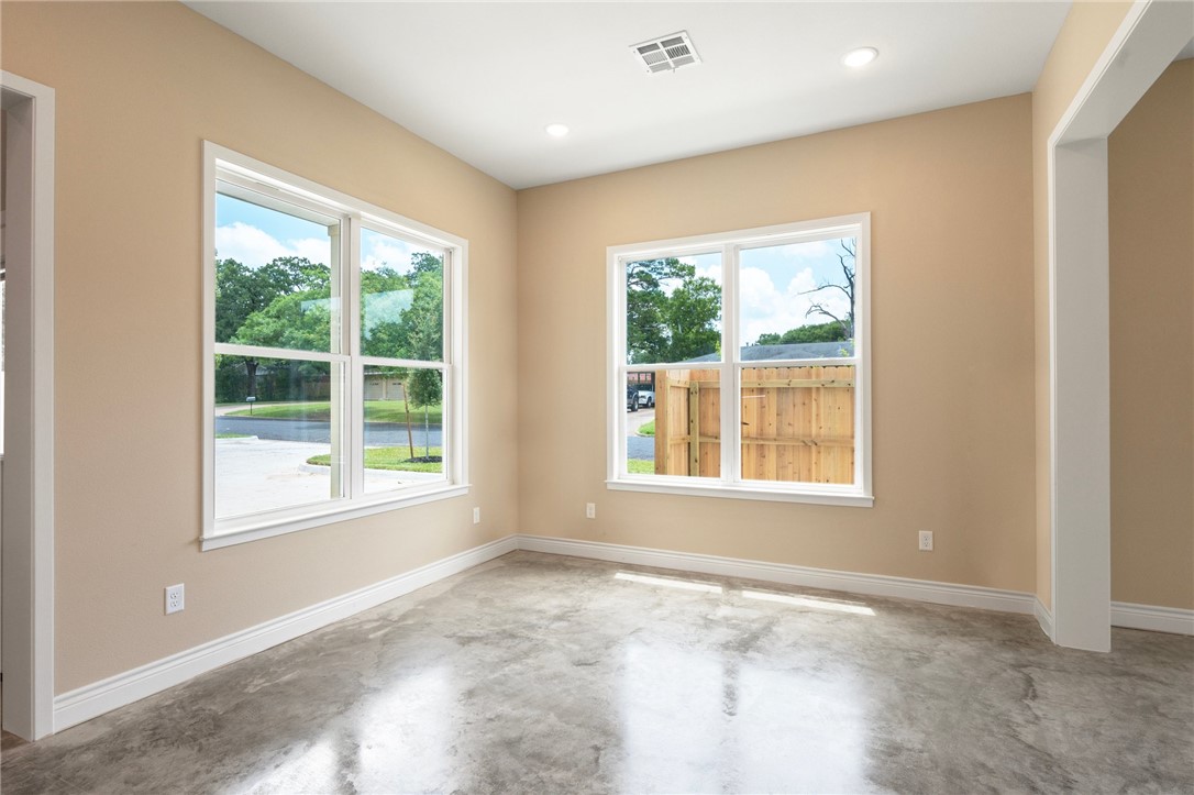 3213 Link Street, Unit 116 Bryan, TX 77801 - Photo 5 of 27 an empty room with wooden floor and windows