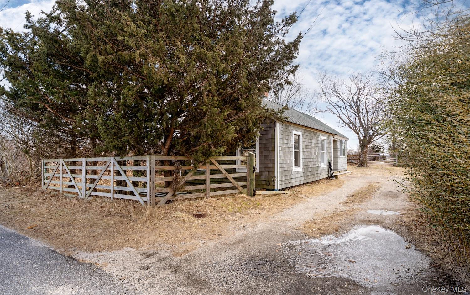 a view of a house with wooden fence