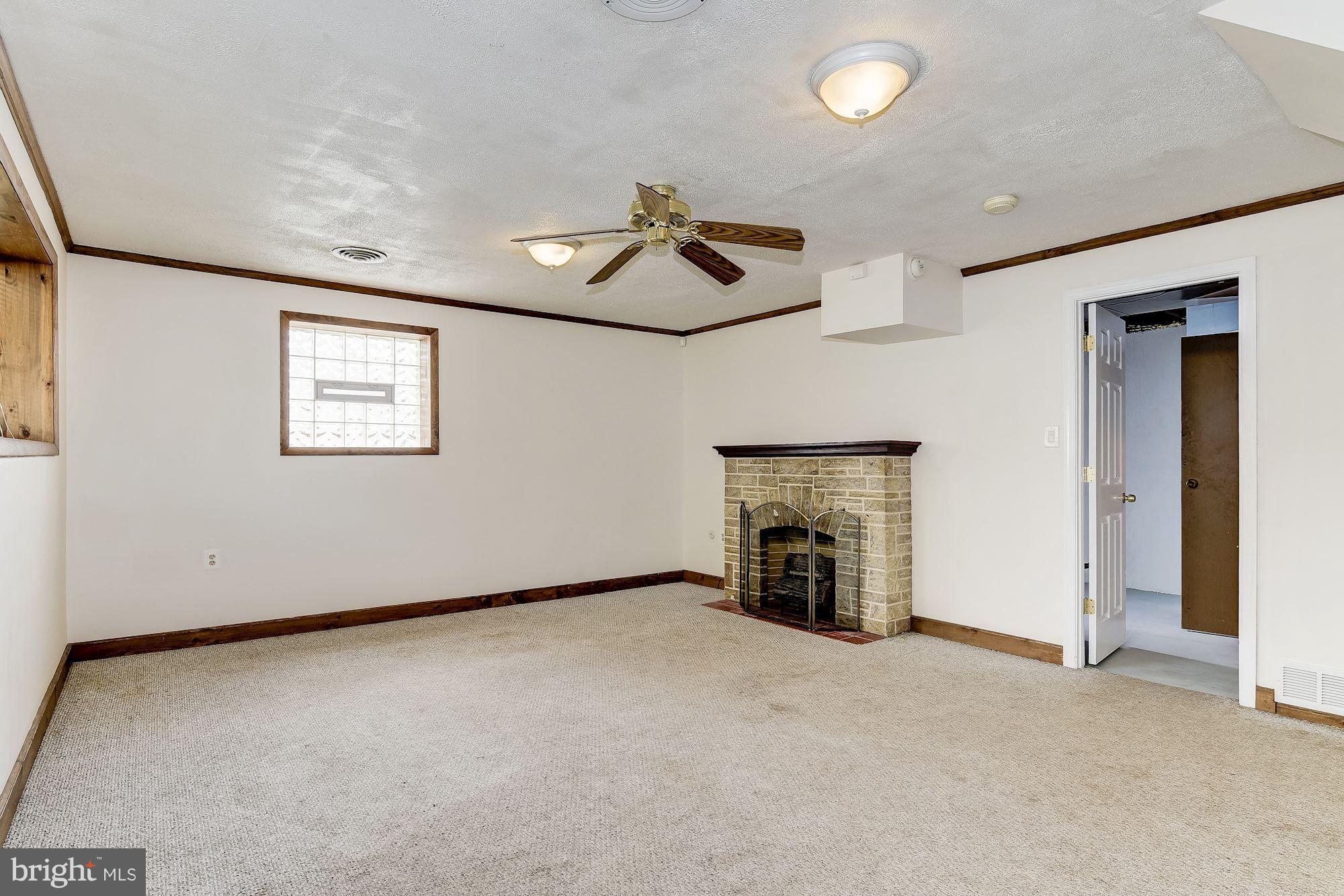 1909 Hanson Road Edgewood, MD 21040 - Photo 21 of 29 an empty room with fireplace and windows