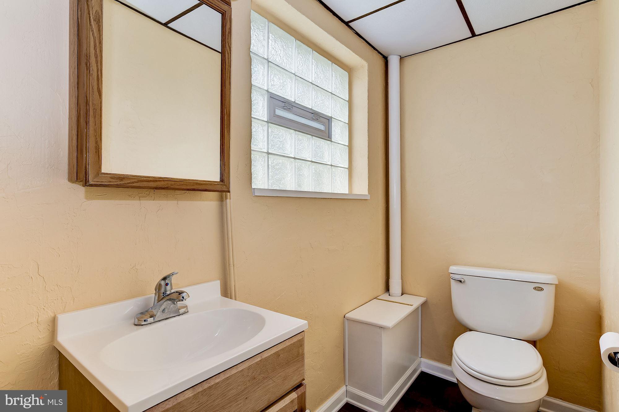 1909 Hanson Road Edgewood, MD 21040 - Photo 24 of 29 a white toilet sitting next to a bathroom sink
