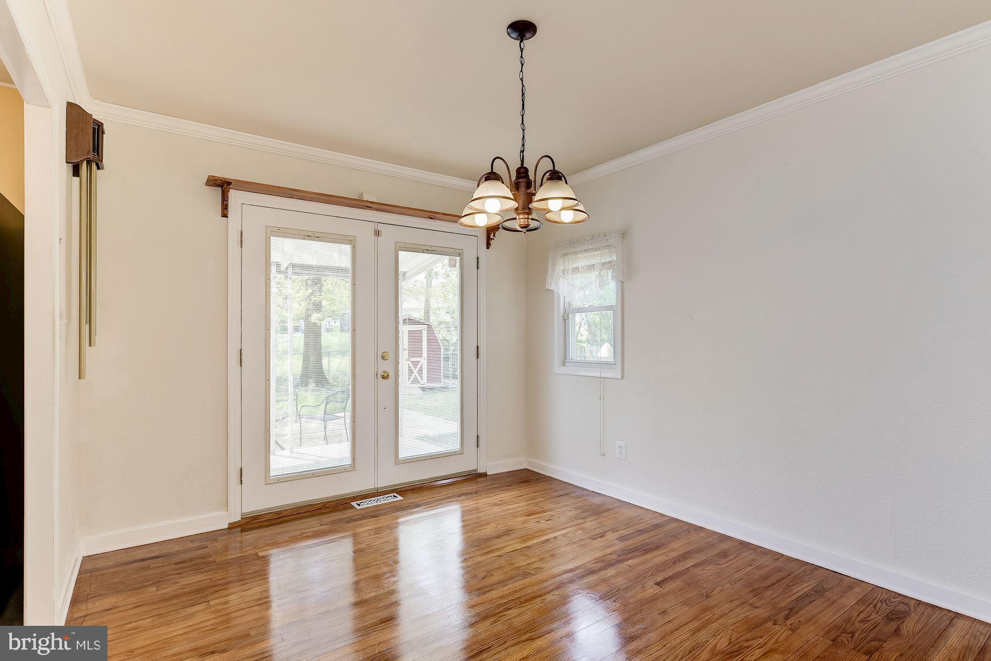 1909 Hanson Road Edgewood, MD 21040 - Photo 7 of 29 a view of an empty room with window and wooden floor