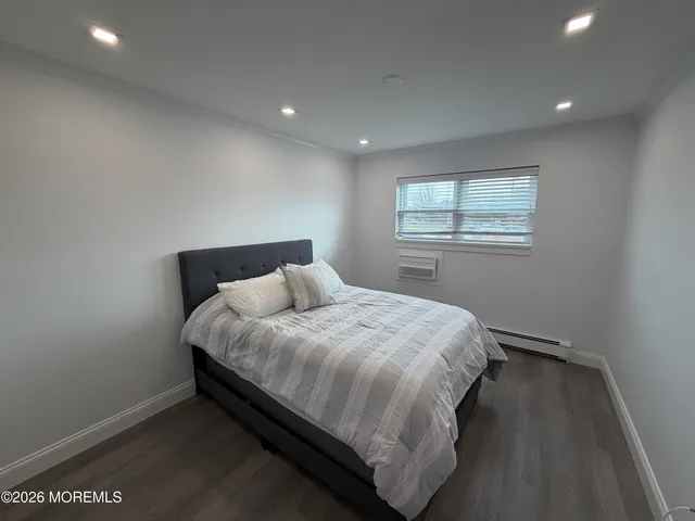 a bed sitting in a bedroom next to a window