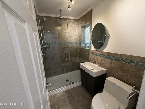 a bathroom with a sink mirror toilet and shower