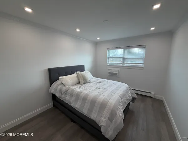 a bed sitting in a bedroom next to a window