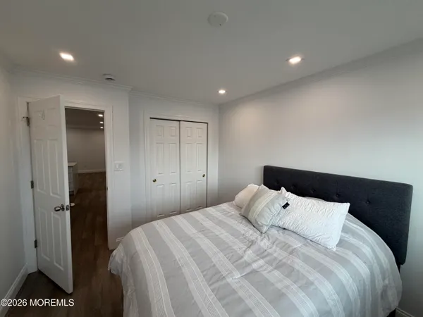 a bedroom with a bed and a night stand