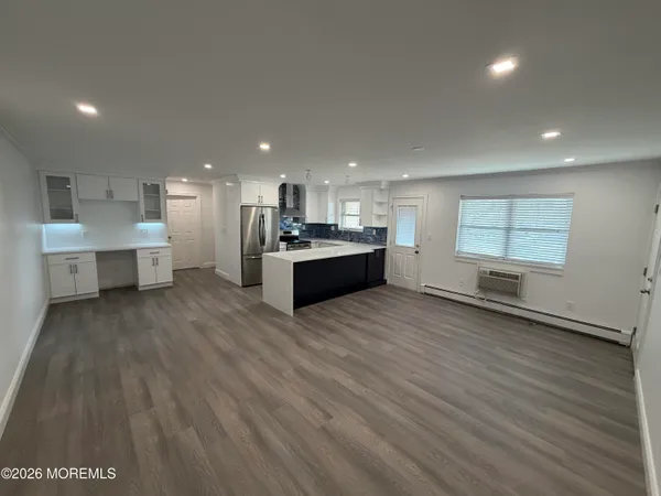 a large kitchen with a large window a sink and stainless steel appliances