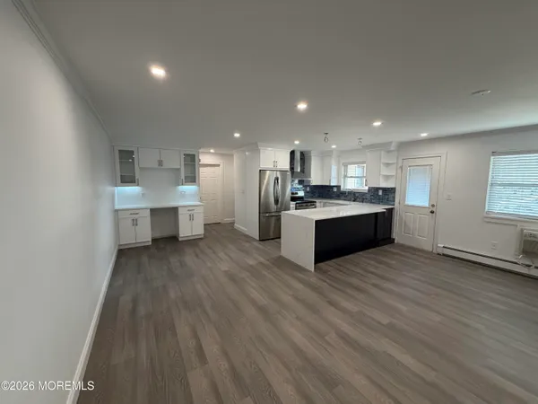 a kitchen with stainless steel appliances a refrigerator and a stove top oven