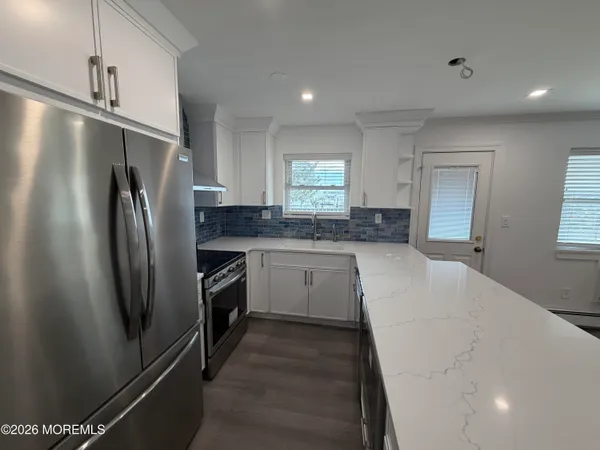 a kitchen with stainless steel appliances a refrigerator sink and stove