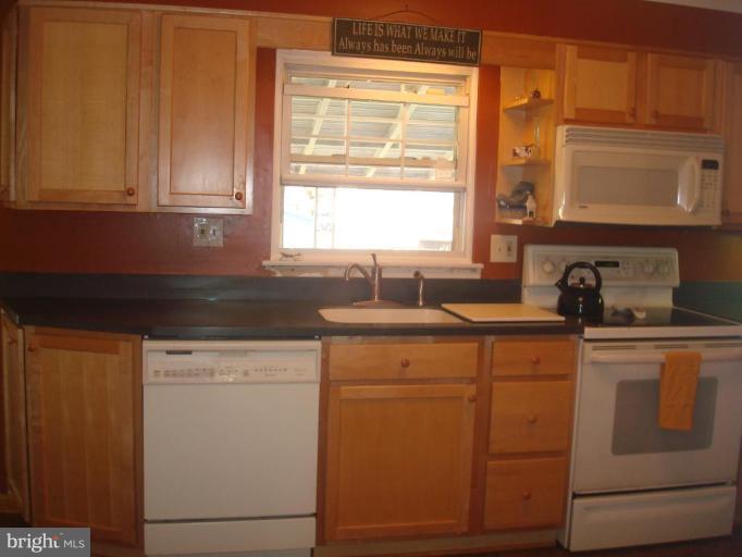 5618 Chelwynd Road Halethorpe, MD 21227 - Photo 8 of 26 a kitchen with cabinets appliances a sink and a window