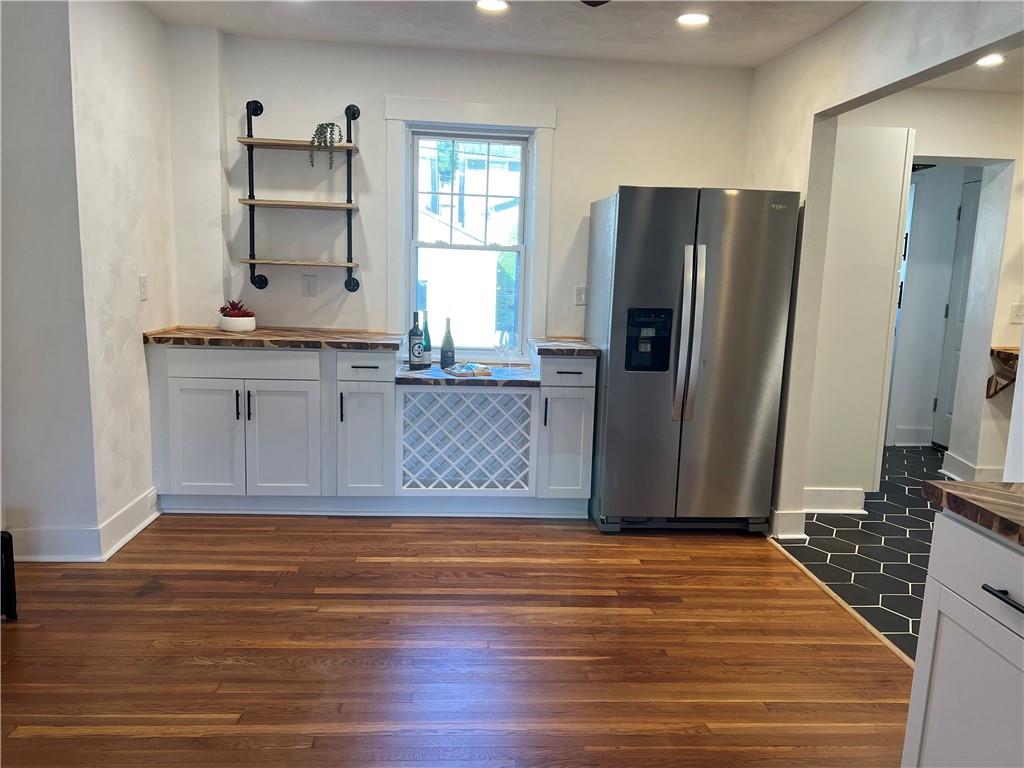 1423 Chislett Street Pittsburgh, PA 15206 - Photo 11 of 47 a view of a kitchen with kitchen island a sink wooden floor and a refrigerator